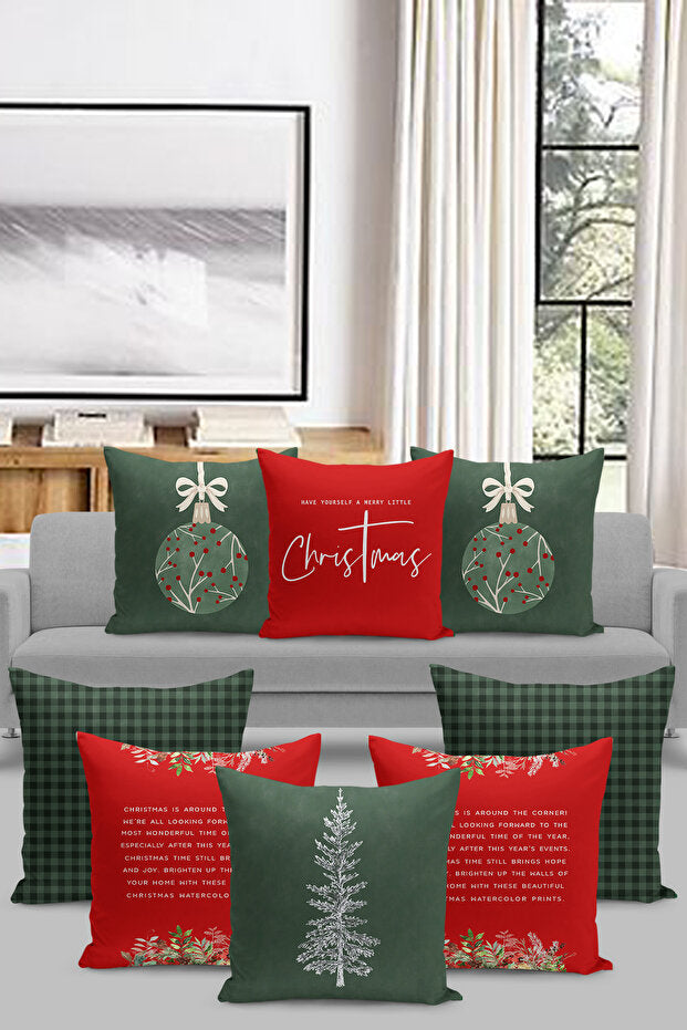 Decorative Christmas pillows on a gray sofa in a living room setting. green pillow, red pillow, christmas tree, ornaments
