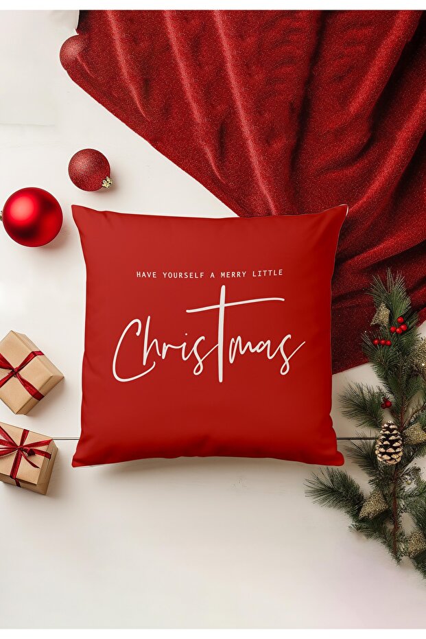 Red pillow with 'Have Yourself a Merry Little Christmas' text, surrounded by Christmas decorations on a white background.