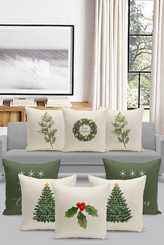 Decorative pillows with Christmas designs on a gray sofa in a living room.
