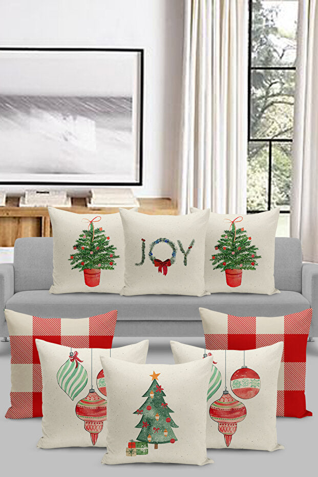 Decorative Christmas pillows on a gray sofa with a window and artwork in the background.